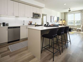 a kitchen with an island and bar stools